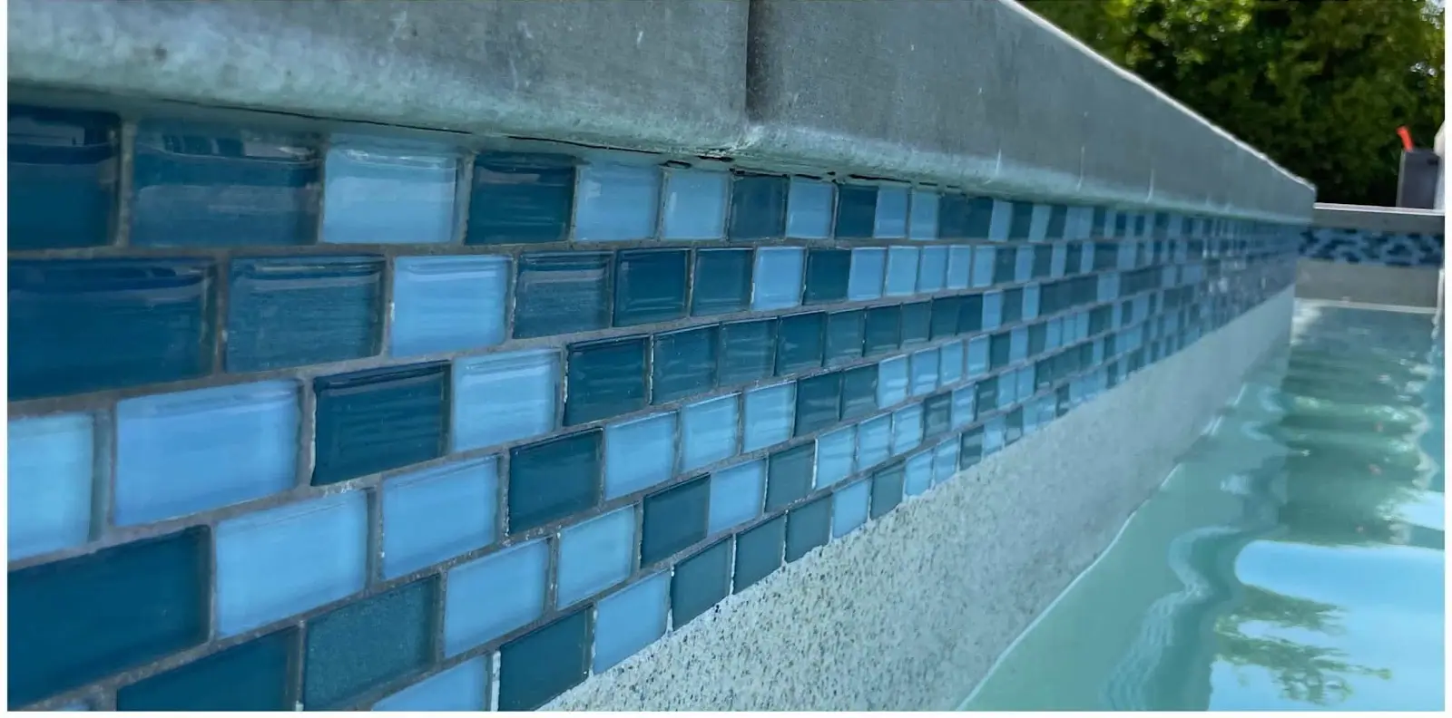 The same blue glass waterline tile with the calcium removed
