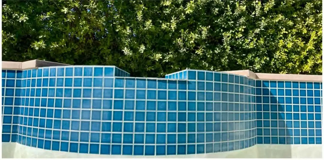 The same blue spa tile cleaned, with no white scale left