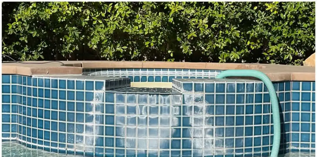 Before: Blue spa tile with white scale where the spillover runs