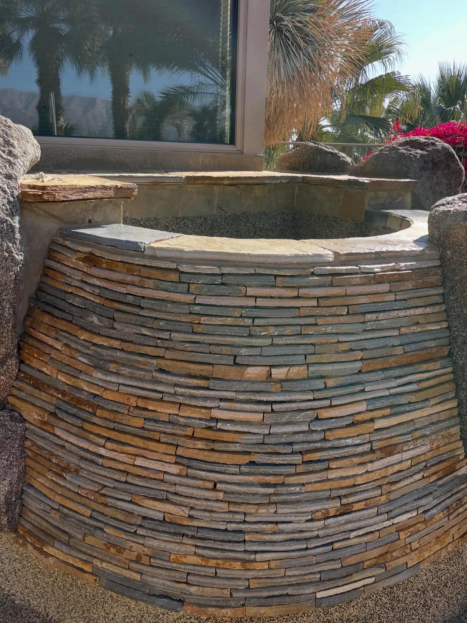 The same stacked stone water feature cleaned, its natural colors showing again